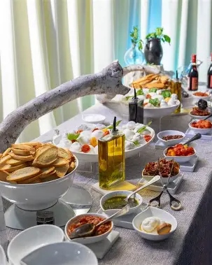 Styled antipasto and burrata corner station spread with cured meats, olives and cheese