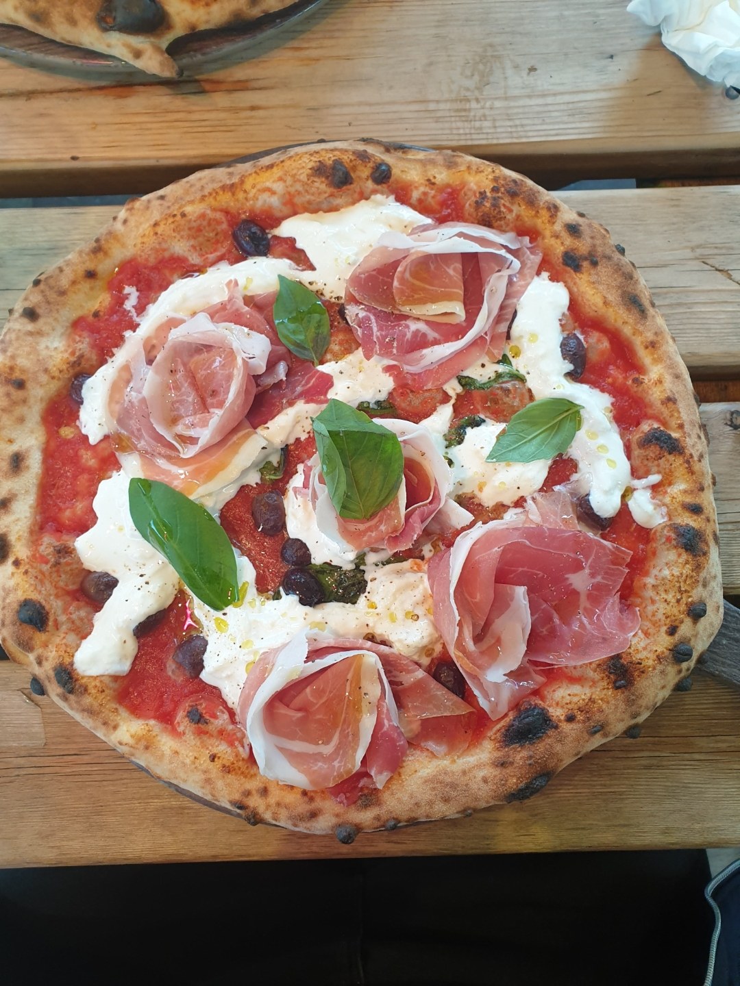 Real fire oven Neapolitan pizza with burrata, prosciutto and basil