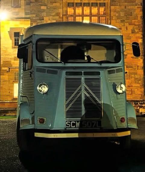 Pizza On The Go van outside a modern office building at night