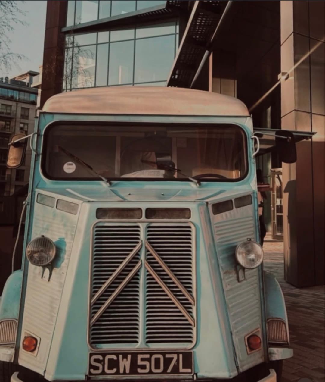 Front view of the vintage Pizza On The Go van in the evening light